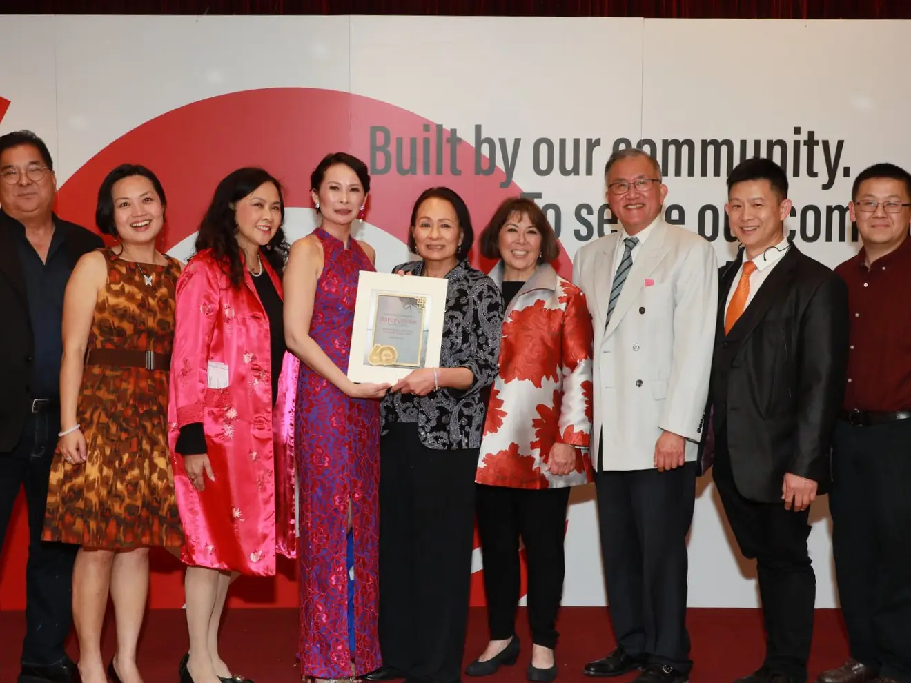 Nancy Lim-Yee holding her award at the 60th Anniversary Gala, surrounded by board members