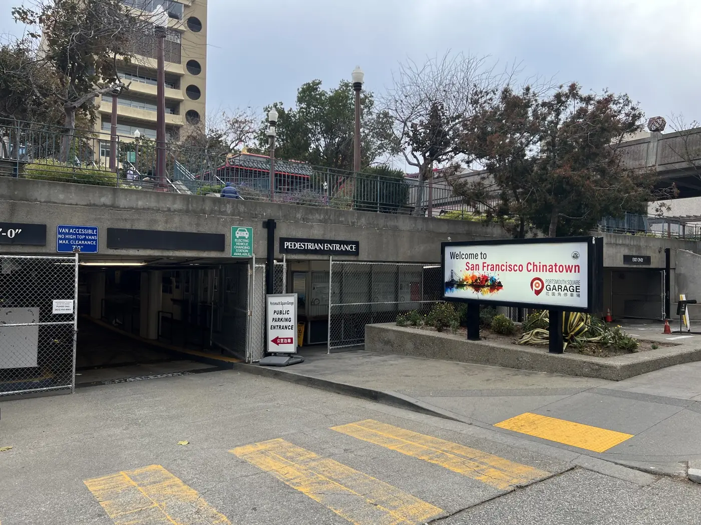 Wide view of the Kearny Street entrance to Portsmouth Square Garage, with the public parking entrance and the Chinatown welcome sign