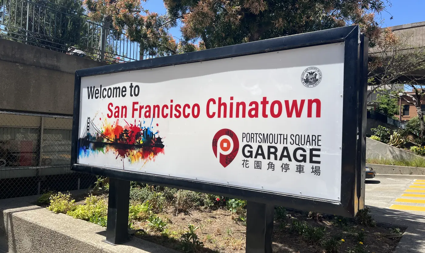 Wide view of the “Welcome to San Francisco Chinatown, Portsmouth Square Garage” sign at the garage entrance on Kearny Street